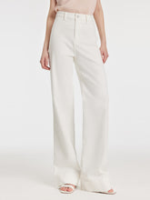 A lady wears a high-waisted white pants.